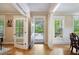 Welcoming foyer showcasing hardwood floors, white trim, and views to the front yard through a glass door at 2078 Marshalls Se Ln, Atlanta, GA 30316