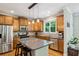 Spacious kitchen with stainless steel appliances, granite countertops, a center island, and wood cabinets at 2078 Marshalls Se Ln, Atlanta, GA 30316