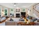 Cozy living room with a fireplace, comfortable seating, and plenty of natural light from multiple windows at 2078 Marshalls Se Ln, Atlanta, GA 30316