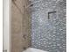 Modern shower with attractive tile work, rainfall showerhead, and built-in niche for storage at 2078 Marshalls Se Ln, Atlanta, GA 30316