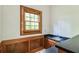 Charming bar area with dark countertop, wooden cabinets, and natural light from window at 4953 Mcpherson Ne Dr, Roswell, GA 30075