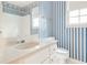 Bright bathroom with white vanity and blue striped walls at 4953 Mcpherson Ne Dr, Roswell, GA 30075