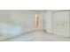 Bedroom featuring neutral carpet, closet doors, and a doorway to another room at 4953 Mcpherson Ne Dr, Roswell, GA 30075