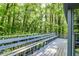 Exterior view of the deck shows the home's connection to the surrounding wooded landscape at 4953 Mcpherson Ne Dr, Roswell, GA 30075