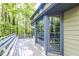 Inviting deck with large glass doors offers scenic views of the surrounding lush greenery at 4953 Mcpherson Ne Dr, Roswell, GA 30075