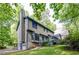 Exterior view of the home showing the large chimney and connection to the surrounding trees at 4953 Mcpherson Ne Dr, Roswell, GA 30075