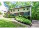 Attractive two-story home with well-maintained lawn, complemented by trees and shrubbery in a serene setting at 4953 Mcpherson Ne Dr, Roswell, GA 30075