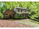 Inviting two-story home with a mix of brick and siding, nestled in a lush, green setting under tree cover at 4953 Mcpherson Ne Dr, Roswell, GA 30075