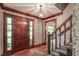 Warm foyer with hardwood floors, wooden staircase, and a grand entrance door, creating a welcoming ambiance at 4953 Mcpherson Ne Dr, Roswell, GA 30075