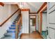 Traditional foyer with hardwood floors, a staircase, and classic wallpaper, creating a welcoming entrance at 4953 Mcpherson Ne Dr, Roswell, GA 30075