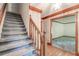 Classic foyer with hardwood floors, carpeted stairs and elegant wallpaper, leading to other rooms in the home at 4953 Mcpherson Ne Dr, Roswell, GA 30075