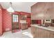 Unique kitchen featuring floral wallpaper, a cooktop island, and an exterior door at 4953 Mcpherson Ne Dr, Roswell, GA 30075