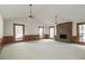 Spacious living room featuring a brick fireplace, large windows, and ample natural light at 4953 Mcpherson Ne Dr, Roswell, GA 30075