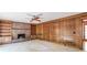 Cozy living room showcasing a fireplace, built-in bookshelves, and paneled walls at 4953 Mcpherson Ne Dr, Roswell, GA 30075