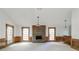 Spacious living room featuring fireplace, bar area, and abundant natural light at 4953 Mcpherson Ne Dr, Roswell, GA 30075