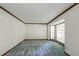 Bright living room featuring a large window, neutral walls, and carpeted floors, creating a cozy space at 4953 Mcpherson Ne Dr, Roswell, GA 30075
