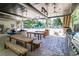 Community outdoor kitchen area with bar seating, stainless steel grill, and nearby picnic tables at 4953 Mcpherson Ne Dr, Roswell, GA 30075