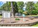 Community playground with play structure, picnic tables and sign with rules at 4953 Mcpherson Ne Dr, Roswell, GA 30075