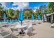 Community pool with tables, chairs, and umbrellas and stairs to upper level at 4953 Mcpherson Ne Dr, Roswell, GA 30075