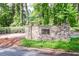 Stone sign at the entrance to Mountain Creek neighborhood with lush landscaping at 4953 Mcpherson Ne Dr, Roswell, GA 30075