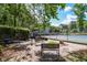 Outdoor patio with benches and tables next to a well-maintained tennis court at 4953 Mcpherson Ne Dr, Roswell, GA 30075