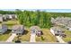 Neighborhood aerial view of homes with manicured lawns, driveways, and tree-lined streets on a sunny day at 7455 Easton Valley Ln, Cumming, GA 30028