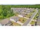 Aerial view of homes in a suburban neighborhood, each with well-maintained lawns and tree-lined streets at 7455 Easton Valley Ln, Cumming, GA 30028