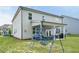 Residential home's backyard featuring lawn with playset and patio with comfortable outdoor seating and a grill at 7455 Easton Valley Ln, Cumming, GA 30028