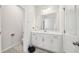 Well-lit bathroom with a sleek white vanity, ample storage, and modern fixtures at 7455 Easton Valley Ln, Cumming, GA 30028