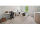 Cozy bedroom with a twin bed, side table, desk, and dresser with carpet flooring and natural light at 7455 Easton Valley Ln, Cumming, GA 30028