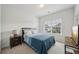 A cozy bedroom with a window view and a side table next to the bed offering a restful space at 7455 Easton Valley Ln, Cumming, GA 30028