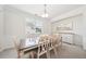Elegant dining room featuring a large table with seating for eight, a modern chandelier, and stylish decor at 7455 Easton Valley Ln, Cumming, GA 30028