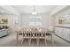 Elegant dining room featuring a large table with seating for eight, a modern chandelier, and stylish decor at 7455 Easton Valley Ln, Cumming, GA 30028