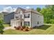 Charming home featuring a well-manicured lawn, brick and vinyl siding, and an attached two-car garage at 7455 Easton Valley Ln, Cumming, GA 30028
