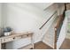 Inviting foyer showcasing a staircase with wood and iron accents and a decorative table at 7455 Easton Valley Ln, Cumming, GA 30028