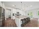 Bright kitchen boasts granite countertops, stainless appliances, and island seating at 7455 Easton Valley Ln, Cumming, GA 30028