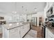 Open-concept kitchen features stainless appliances, granite countertops, and eat-in island at 7455 Easton Valley Ln, Cumming, GA 30028