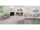 Comfortable living area with fireplace, plush seating, and large windows providing natural light at 7455 Easton Valley Ln, Cumming, GA 30028