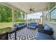 Inviting covered patio featuring comfortable lounge seating and views of the lush backyard and surrounding greenery at 7455 Easton Valley Ln, Cumming, GA 30028