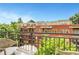 Balcony view of trees and other residences with a small table and two chairs at 1055 Piedmont Ne Ave # 409, Atlanta, GA 30309