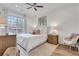 Bright bedroom with a ceiling fan, white walls, and a large window to let in sunlight at 1055 Piedmont Ne Ave # 409, Atlanta, GA 30309