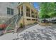 Building entrance featuring a staircase and a stone exterior at 1055 Piedmont Ne Ave # 409, Atlanta, GA 30309