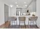 Stylish kitchen with gray cabinets, stainless appliances, a breakfast bar, and three rattan bar stools at 1055 Piedmont Ne Ave # 409, Atlanta, GA 30309