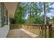 Relaxing back deck with wood railing overlooks the greenery at 1839 Belcher Pl, Austell, GA 30168