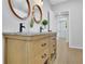 Bathroom vanity with double sinks, granite countertop, stylish mirrors, and a view into another room at 1839 Belcher Pl, Austell, GA 30168