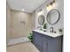 Charming bathroom with double sink vanity, round mirrors and a tiled shower at 1839 Belcher Pl, Austell, GA 30168