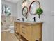 Stylish bathroom featuring a double vanity with granite countertops and round mirrors at 1839 Belcher Pl, Austell, GA 30168