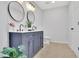 Stylish bathroom with a double sink vanity, round mirrors, and modern fixtures at 1839 Belcher Pl, Austell, GA 30168