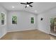 Bright and airy bedroom with a ceiling fan, two windows and back deck access at 1839 Belcher Pl, Austell, GA 30168