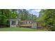 Beautiful house with a front porch, surrounded by mature trees and lush landscaping at 1839 Belcher Pl, Austell, GA 30168